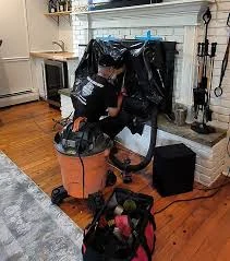 Fireplace service setup with protective coverings and cleaning equipment